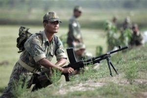 File photo of a police officer maning his position before proceeding inside the villages of Lalgarh, some 170 km (106 miles) west of Kolkata, June 18, 2009. REUTERS/Jayanta Shaw/Files