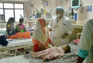 Gorakhpur: Children receive treatments in the Encephalitis  Ward at the Baba Raghav Das Medical College Hospital in Gorakhpur district on Sunday. More than 30 children have died at the hospital in the span of 48 hours. PTI Photo    (PTI8_13_2017_000202B)