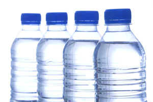 image of four bottled water in line