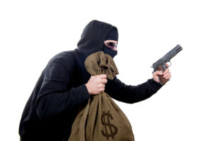 hooded robber with a gun and a bag of money