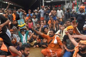 Sabarimala: Protesters oppose the entry of women to the Sabarimala Temple, Kerala, Friday, Oct 19, 2018. Rehana Fathima and journalist Kavitha Jakkal were escorted to the temple but the priest reportedly locked it and the women had to return mid-way. (PTI Photo)  (PTI10_19_2018_000069B)