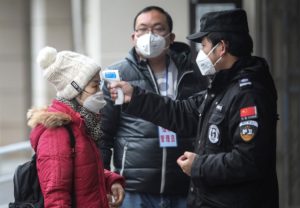 WUHAN, CHINA - JANUARY 22: (CHINA OUT) Security personnel check the temperature of passengers in the Wharf at the Yangtze River on January 22, 2020 in Wuhan, Hubei province, China. A new infectious coronavirus known as "2019-nCoV" was discovered in Wuhan as the number of cases rose to over 400 in mainland China. Health officials stepped up efforts to contain the spread of the pneumonia-like disease which medicals experts confirmed can be passed from human to human. The death toll has reached 17 people as the Wuhan government issued regulations today that residents must wear masks in public places. Cases have been reported in other countries including the United States, Thailand, Japan, Taiwan, and South Korea.  (Photo by Getty Images)