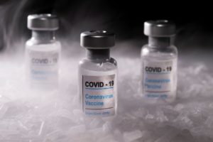 FILE PHOTO: Vials labelled "COVID-19 Coronavirus Vaccine" are placed on dry ice in this illustration taken, December 4, 2020. REUTERS/Dado Ruvic/Illustration